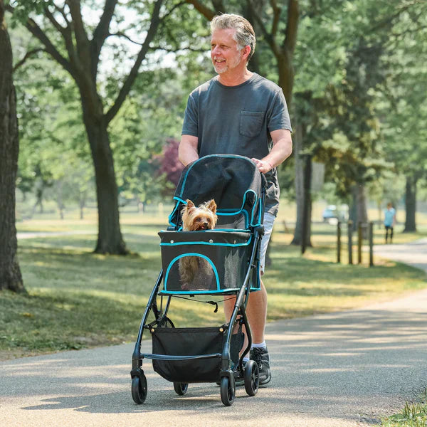 Man walking a Yorkshire Terrier dog in a pet stroller in the park - pet strollers at Happy Furry UK